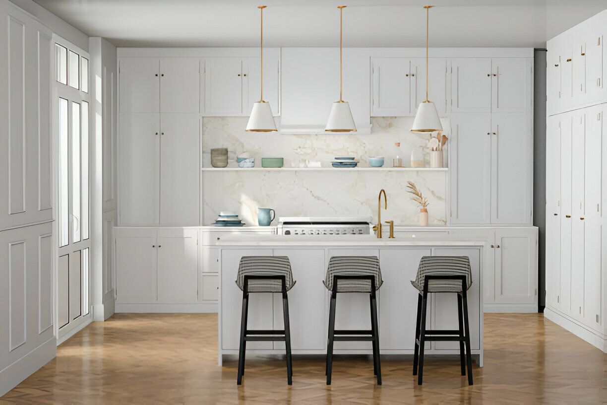 Bright white kitchen with gold accents, marble backsplash, pendant lighting, herringbone wood flooring, and an island with bar stools