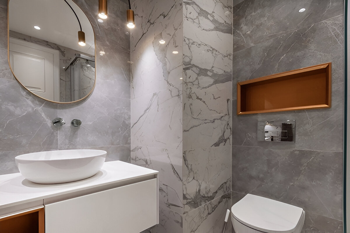 A contemporary bathroom featuring marble walls, a white vessel sink, a floating vanity, and a wall-mounted toilet.