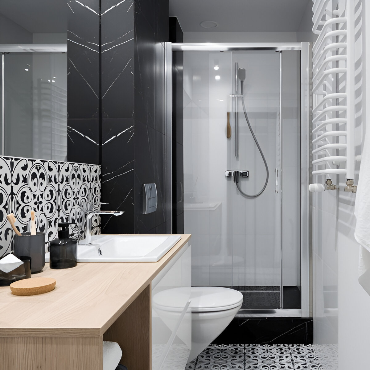 A stylish black and white bathroom featuring a glass-enclosed walk-in shower, patterned tiles, and a wooden vanity.