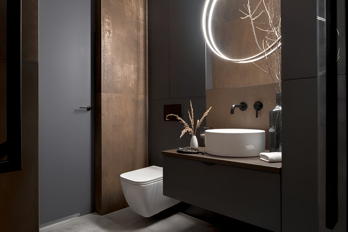 Contemporary bathroom design featuring a floating vanity, round vessel sink, and backlit circular mirror