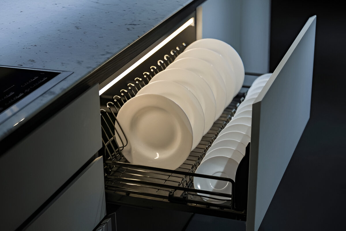 Modern drawer dish rack with white plates under cabinet lighting