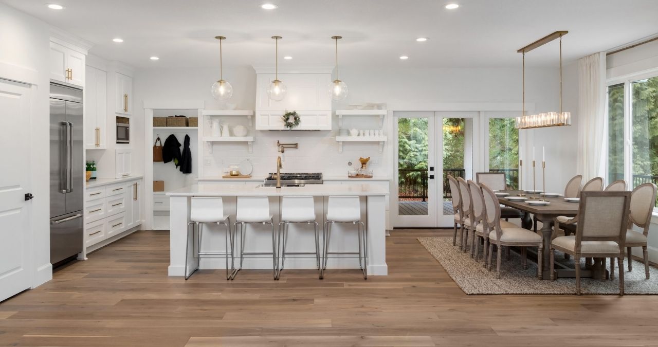 Bright open-concept kitchen and dining area with wood-look tile flooring