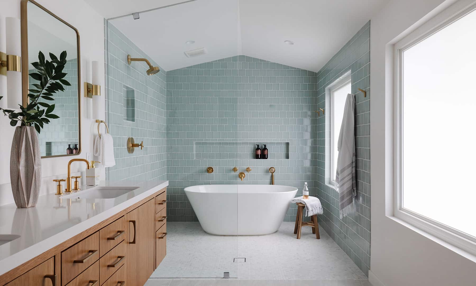 Spa-like bathroom with light turquoise tiles and freestanding tub