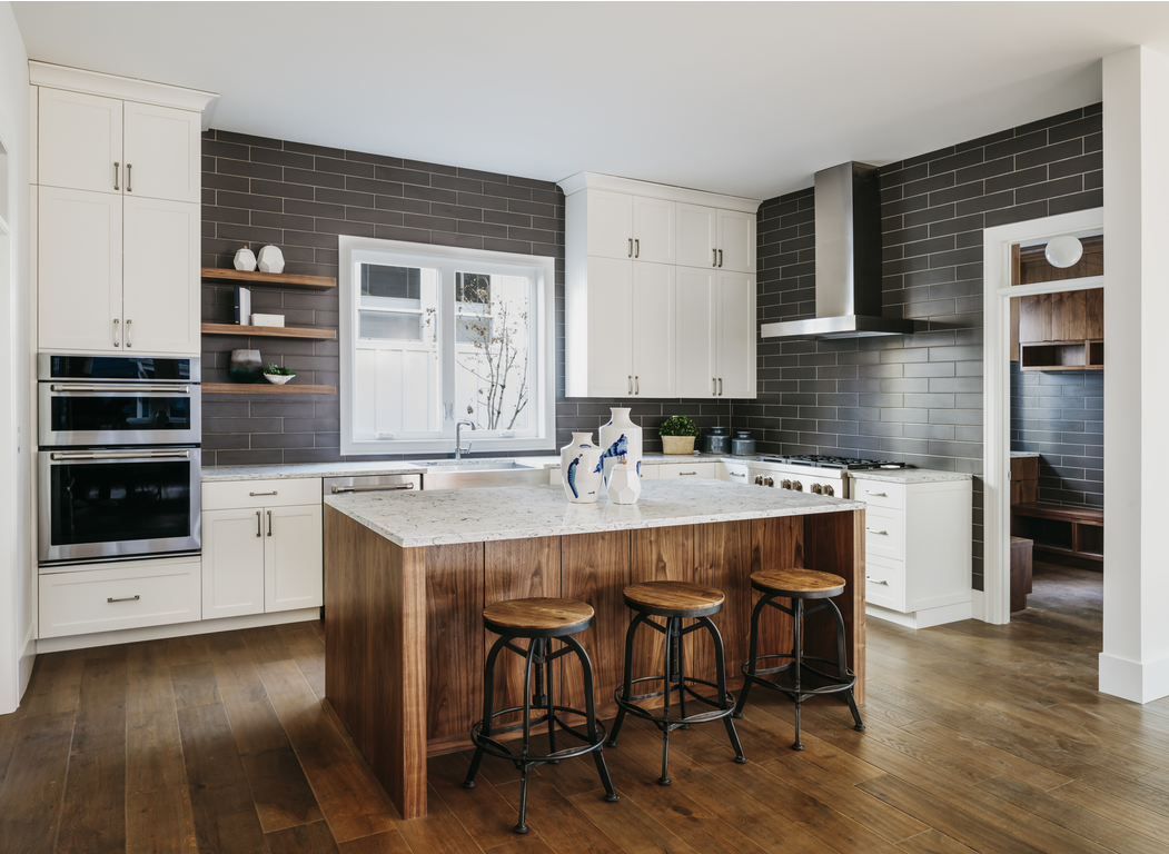 Modern kitchen with dark subway tile backsplash and wood-effect tile flooring
