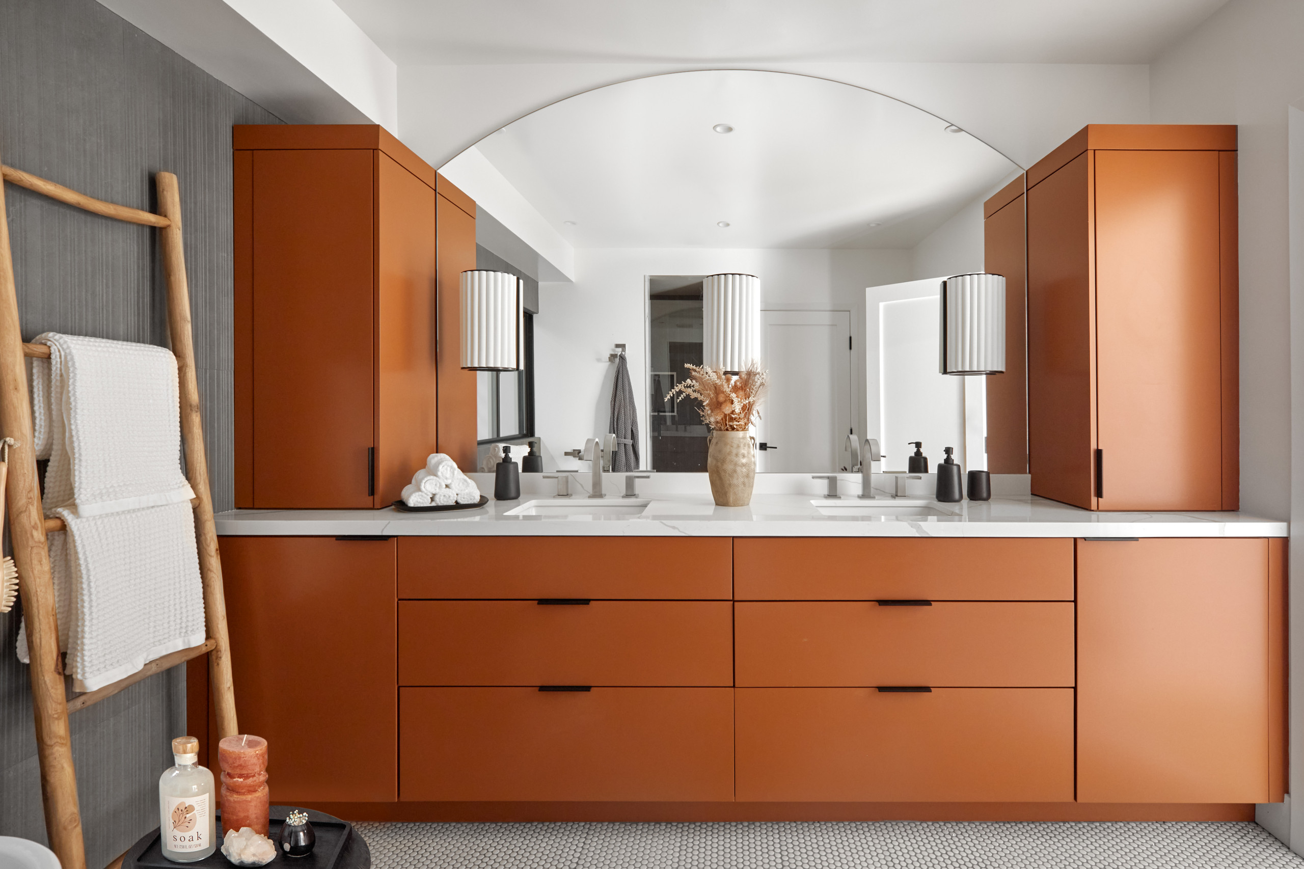 Modern bathroom with terracotta double vanity, large mirror, and pendant lighting