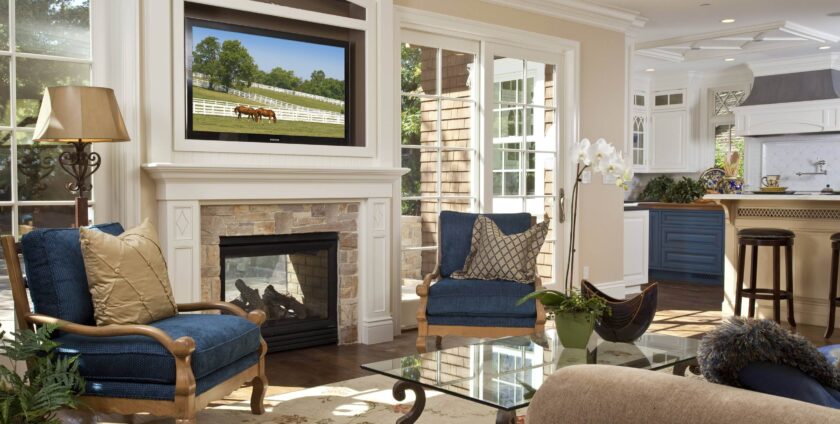 Traditional living room with stone fireplace, blue armchairs, and glass coffee table
