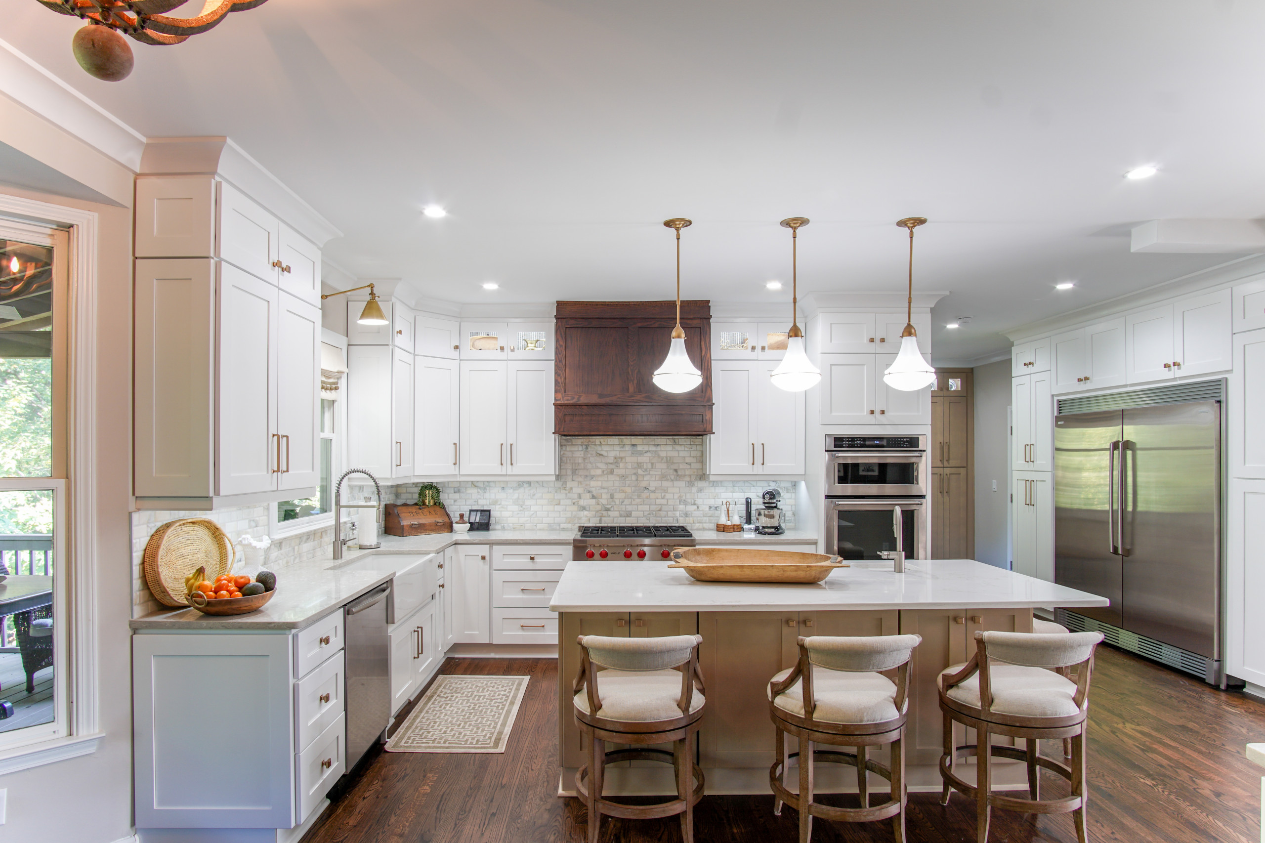 Modern kitchen with white cabinetry, large island, and pendant lighting